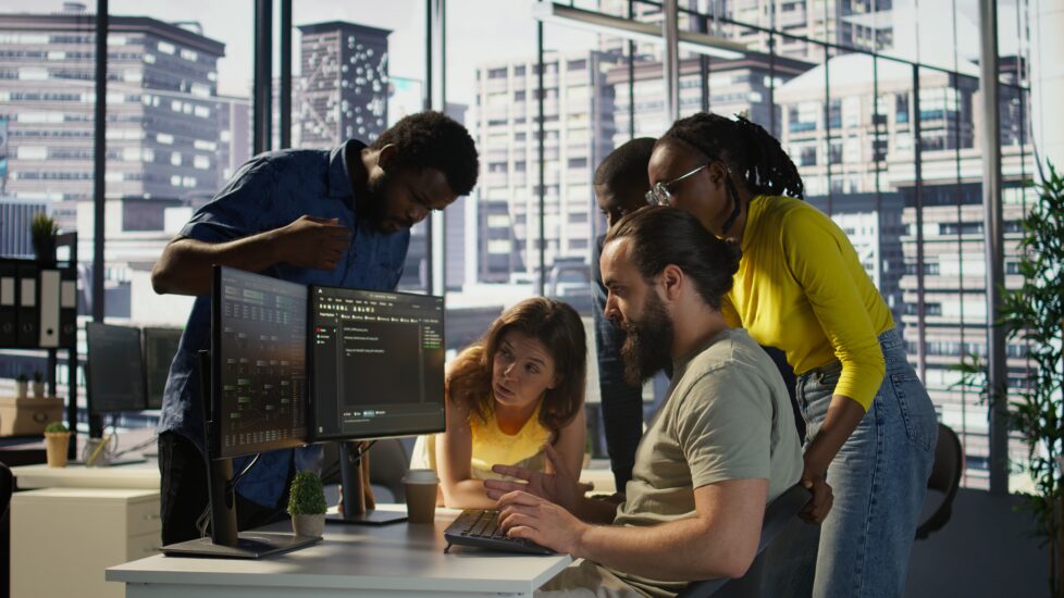 A team of software developers collaborating on a project plan.